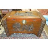 A 20th century camphor-wood-lined blanket box, the front and lid carved with figures and pagoda,