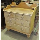 A stripped pine wash stand, the rectangular tray top above two small and two long drawers, on turned