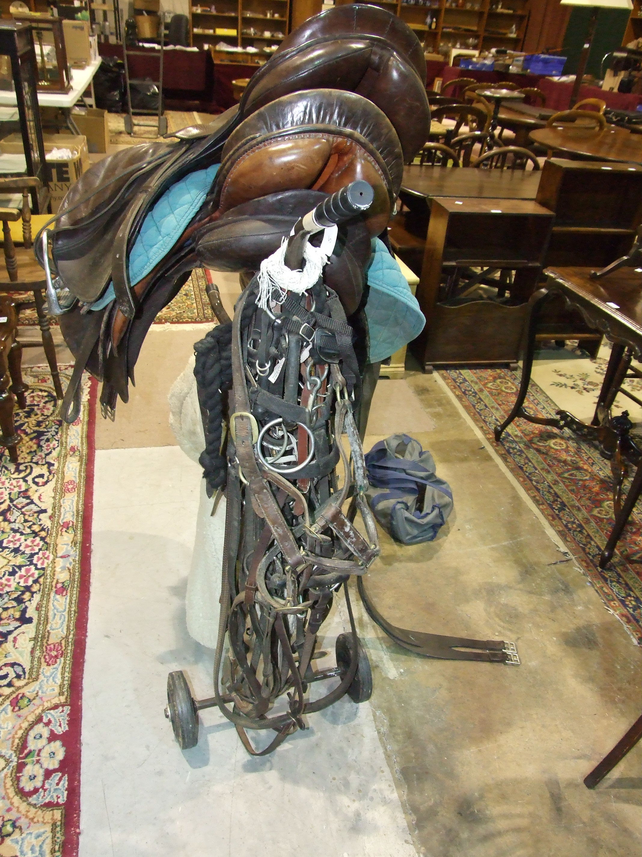 Three leather saddles, miscellaneous bridles and a metal saddle stand. - Image 3 of 4