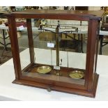 A set of Becker's Sons, Rotterdam, brass laboratory scales in glazed mahogany case, 43cm high,