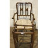 An Edwardian inlaid armchair with padded seat, on tapering front legs and an oak four-division stick