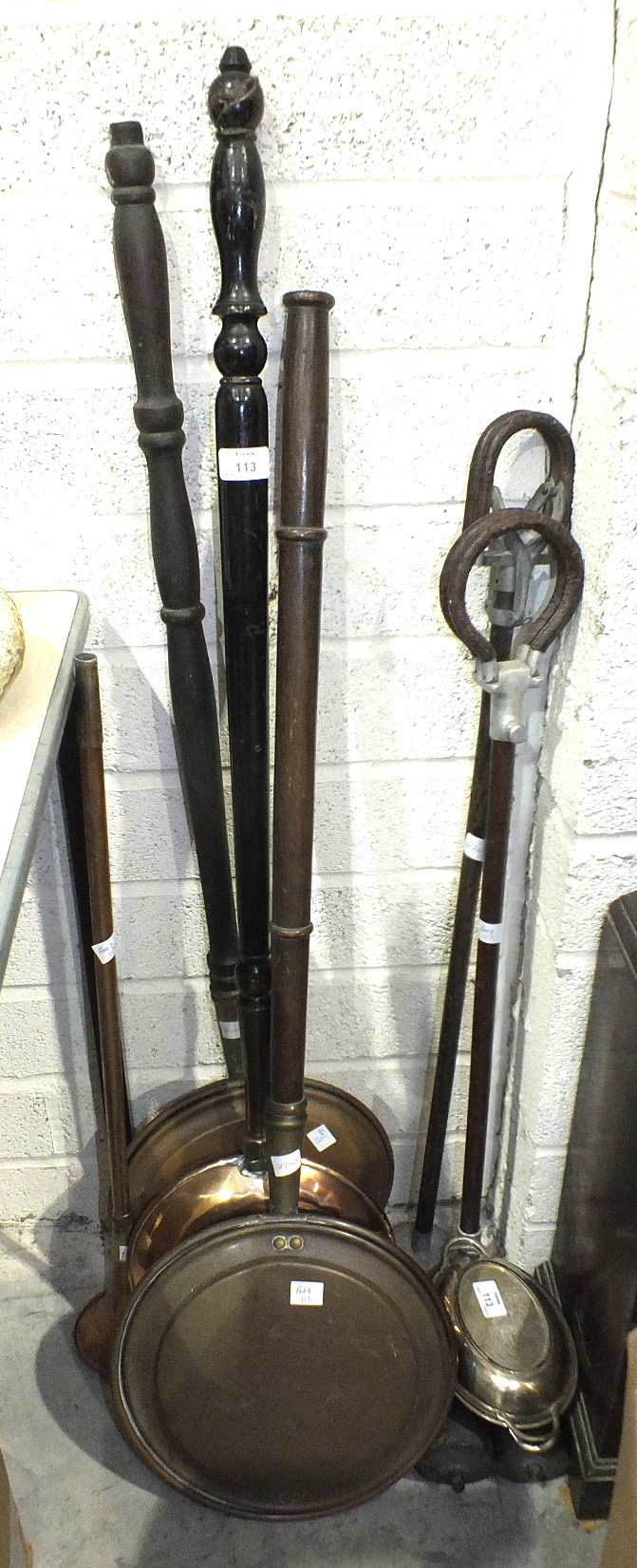 Three copper bed warmers with turned wood handles, two shooting sticks and other items.