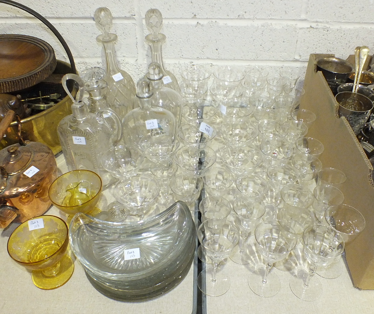 A collection of cut glass and other glassware, including a ship's decanter, five other decanters,