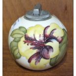 A Moorcroft ball-shaped cream-glazed table lighter decorated in the Hibiscus pattern, paper label to