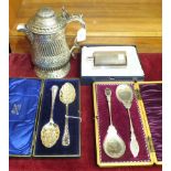 A 19th century silver-plated lidded tankard, 23cm high, two cased sets of berry spoons and a