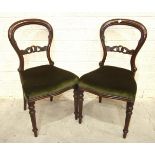 A set of eight Victorian-style balloon-back mahogany dining chairs with serpentine seats, on