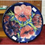 A Moorcroft charger decorated with anemones, impressed Moorcroft, made in England and painted WM
