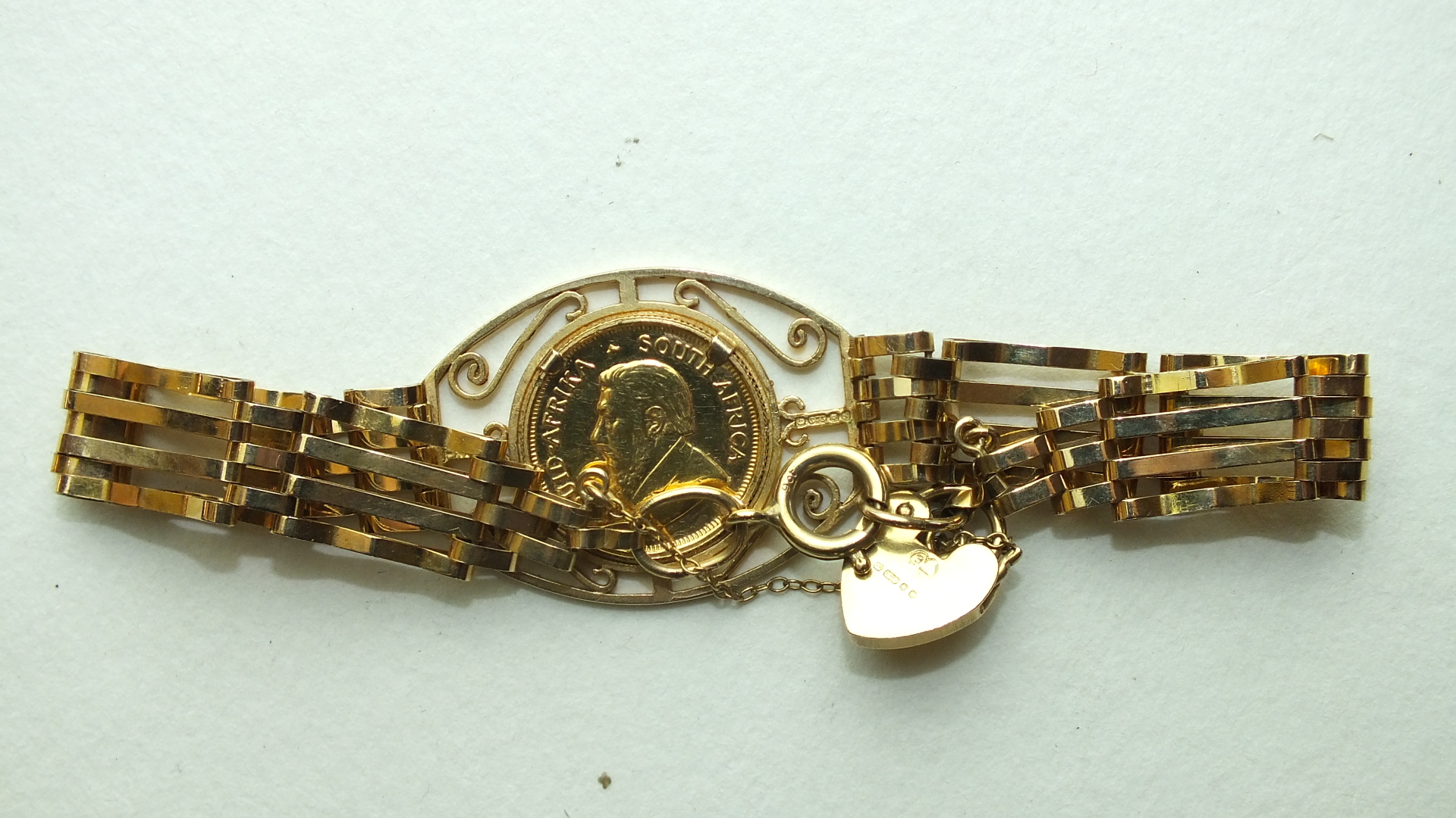 A 1/10 Krugerrand 1980 in a 9ct gold gate-link bracelet, 11.8g. - Image 2 of 2