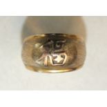 A gold ring with Chinese character, on textured ground, marked '14k', size L.