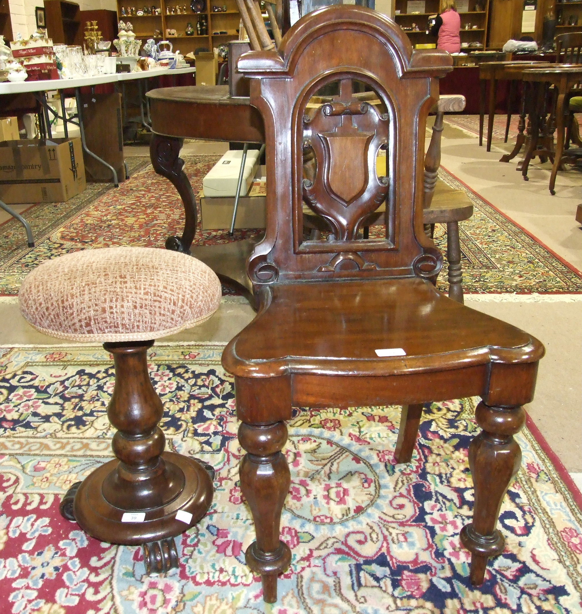 A Victorian mahogany hall chair, with pierced shield back on octagonal shaped front legs and a