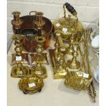 A collection of brass and copper ware, including candlesticks, kettle, fire brasses, jam pots and
