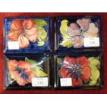 Four Moorcroft rectangular blue-glazed lids, each decorated with hibiscus flowers, 12.5 x 9cm, (4).