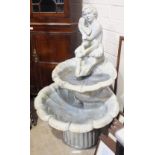 A Henri Studio cast concrete two-tier shell water feature surmounted with a seated figure holding