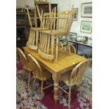 A modern pine kitchen table, six wheel-back chairs and four lathe-back chairs.