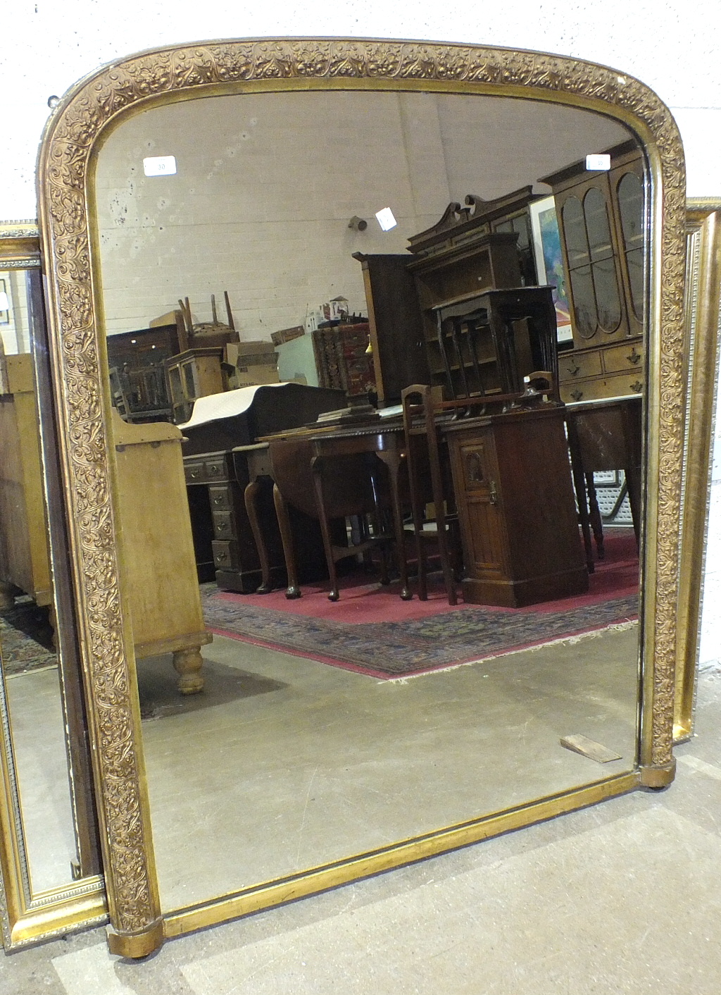 A Late-Victorian gilt-framed arched over-mantel mirror, 127 x 104cm.