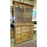 An early-19th century mahogany secretaire/bookcase having a pair of astragal-glazed doors above a