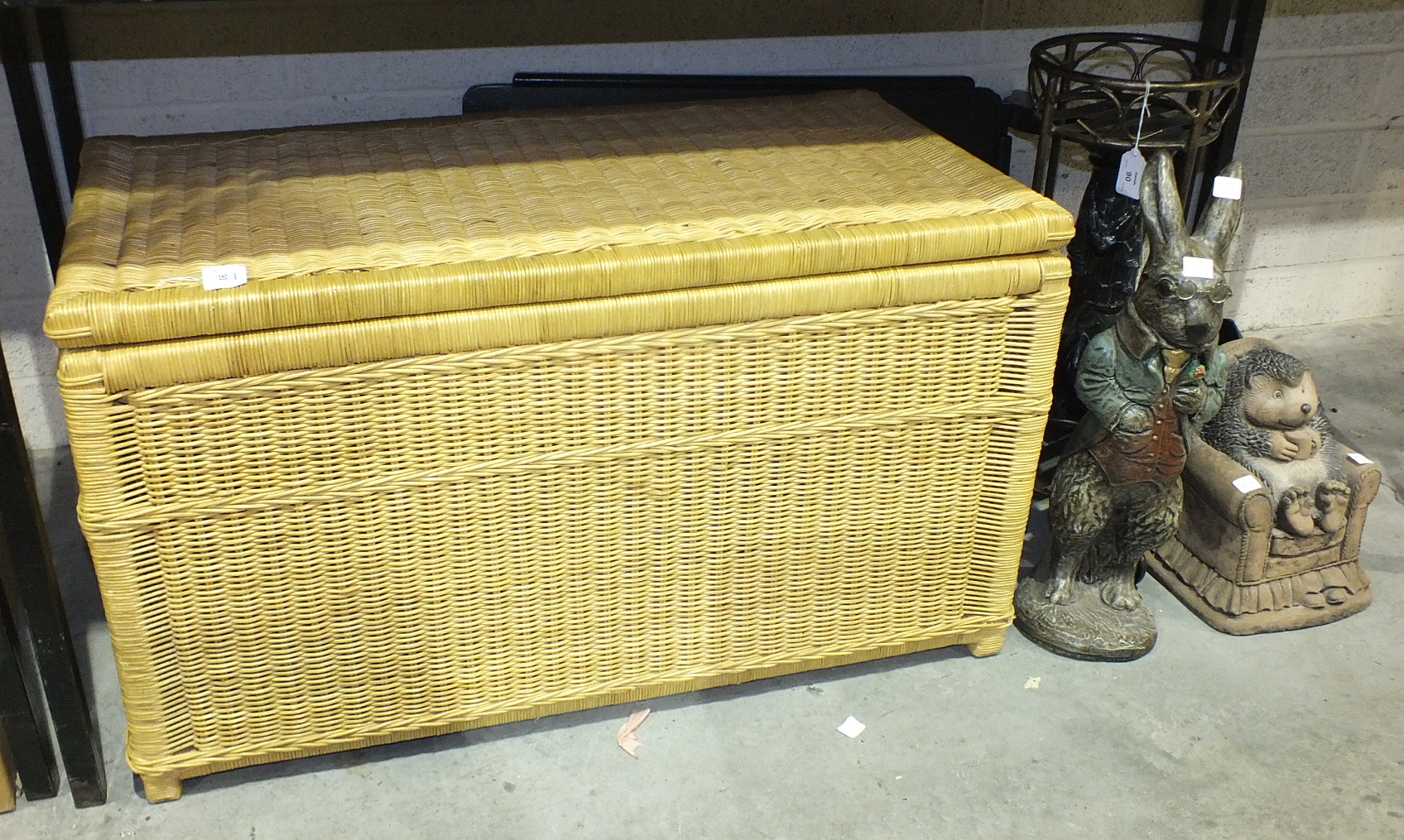 A large wicker basket, 85 x 44cm, 47cm high, a folding table and other items.