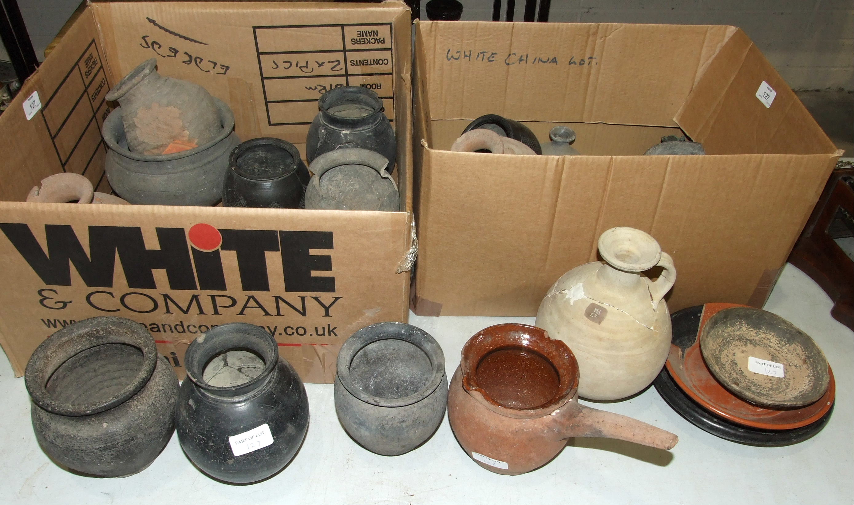 A collection of archaeological dig pottery finds, some with 'Newbury Collection' stickers.