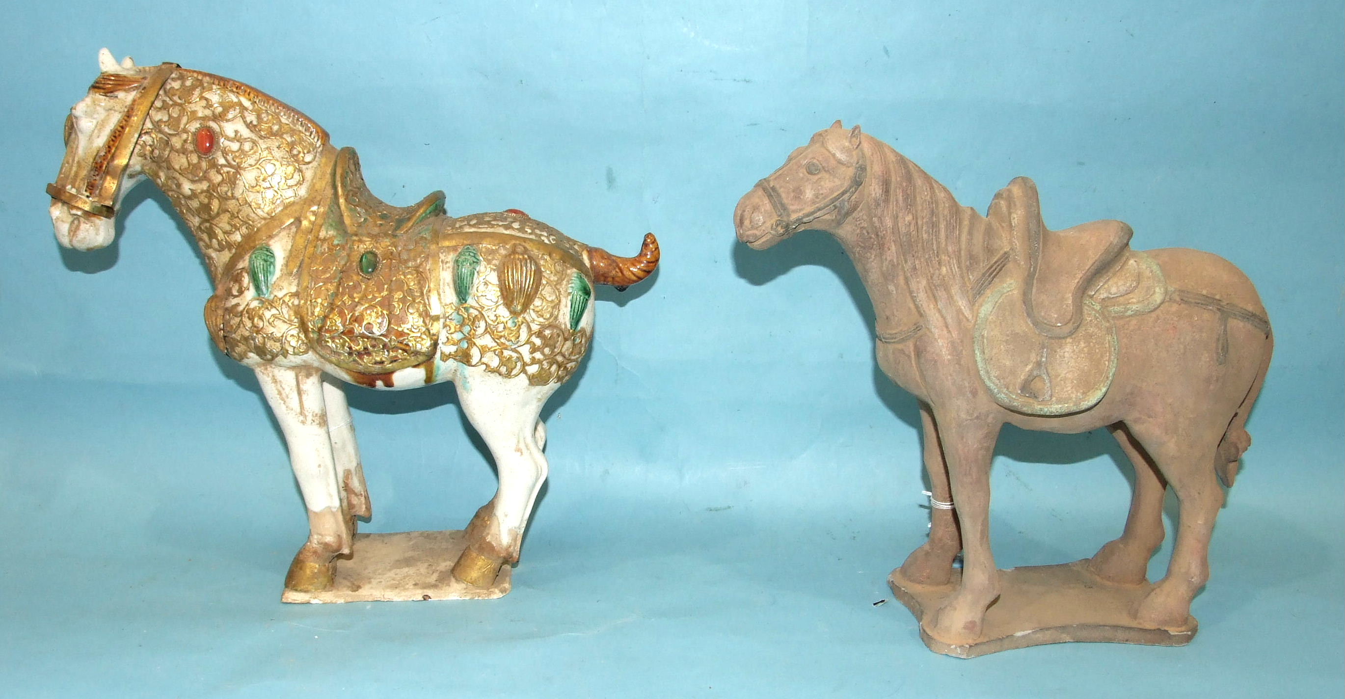 Three Tang-style earthenware horses, one with gilded decoration, (3).