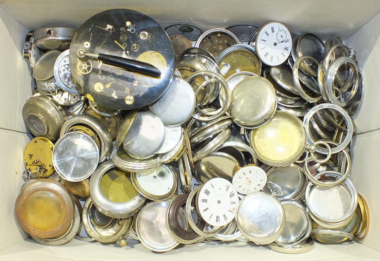 A large quantity of pocket watch movements, metal cases, and other pocket watch parts.