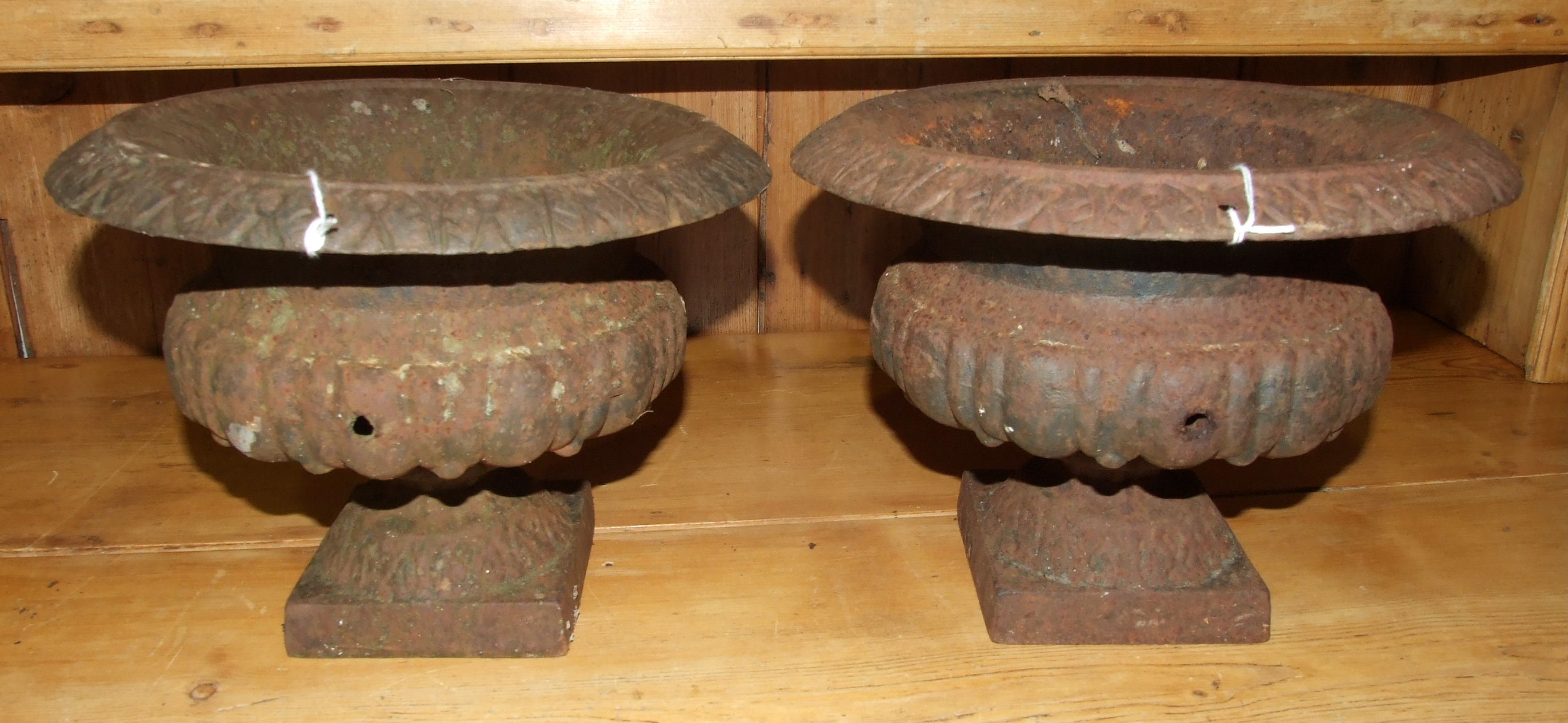 A pair of small cast iron campana-shaped urns, 27cm diameter, 19cm high, (2).