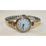 A ladies 9ct-gold-cased Vertex wrist watch on plated expanding bracelet.