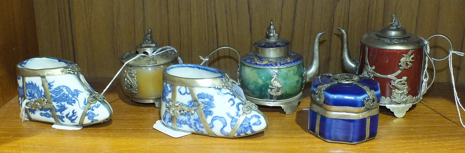 Six Oriental metal-mounted porcelain vessels: two shoes, two teapots and two covered jars, (6).