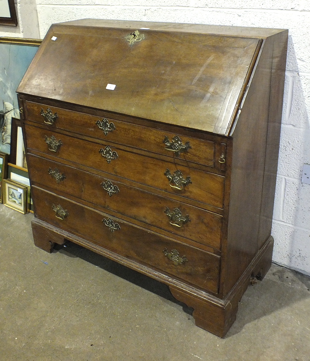 A 19th century mahogany bureau, the rectangular top and fall front above four drawers, on bracket