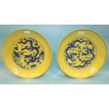 Two similarly-decorated yellow and blue dragon dishes, in Ming style, 36cm diameter, (2).