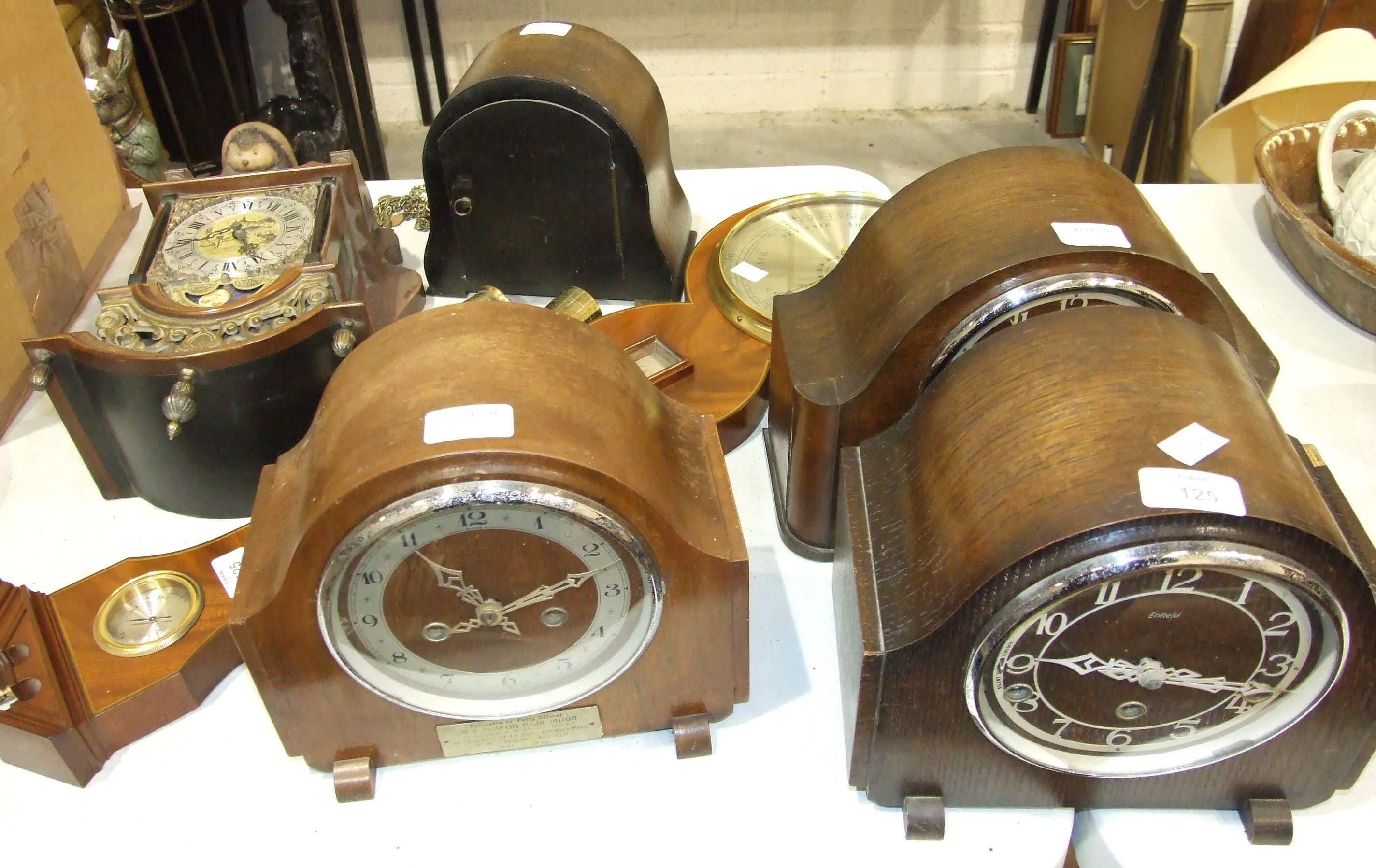 An Enfield oak-cased chiming mantel clock, three oak case striking mantel clocks, a reproduction