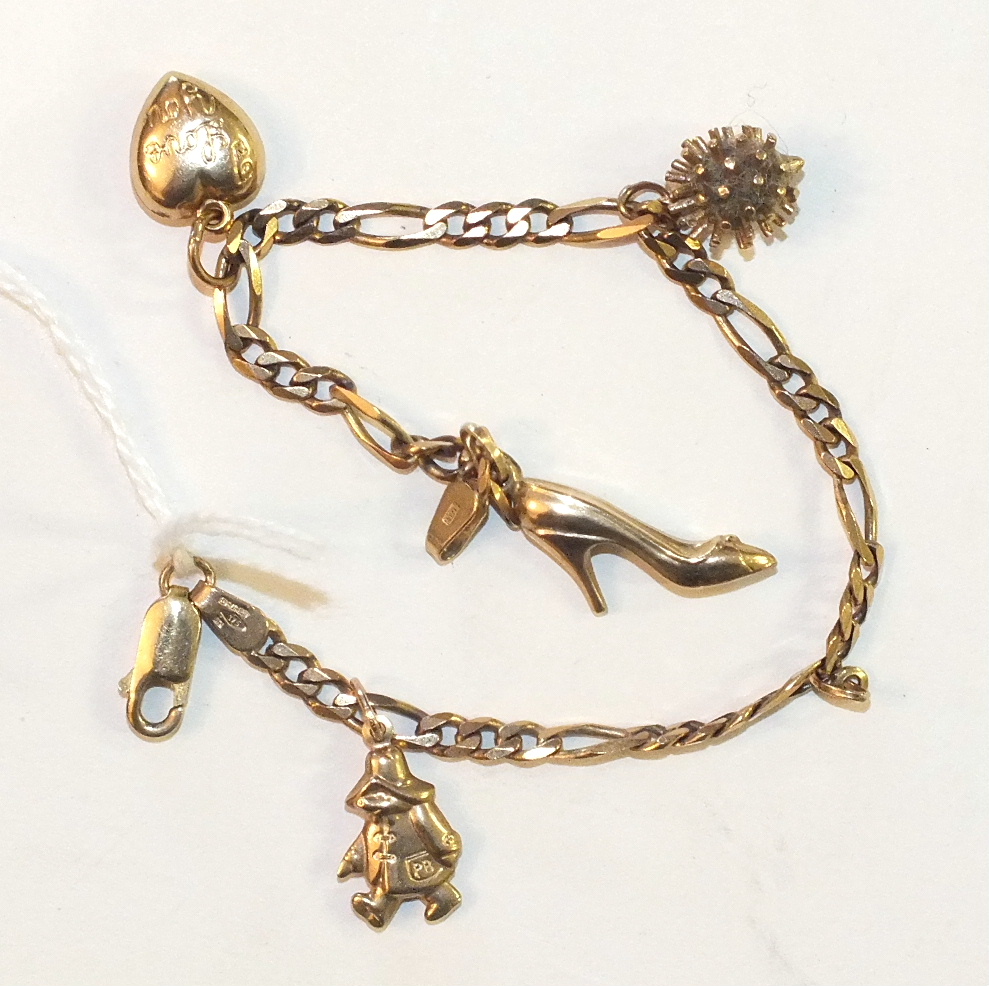 A 9ct gold curb-link bracelet with four charms, 6.6g.