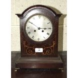 An inlaid mahogany mantel clock of arch form, with French drum gong-striking movement, 33cm high and