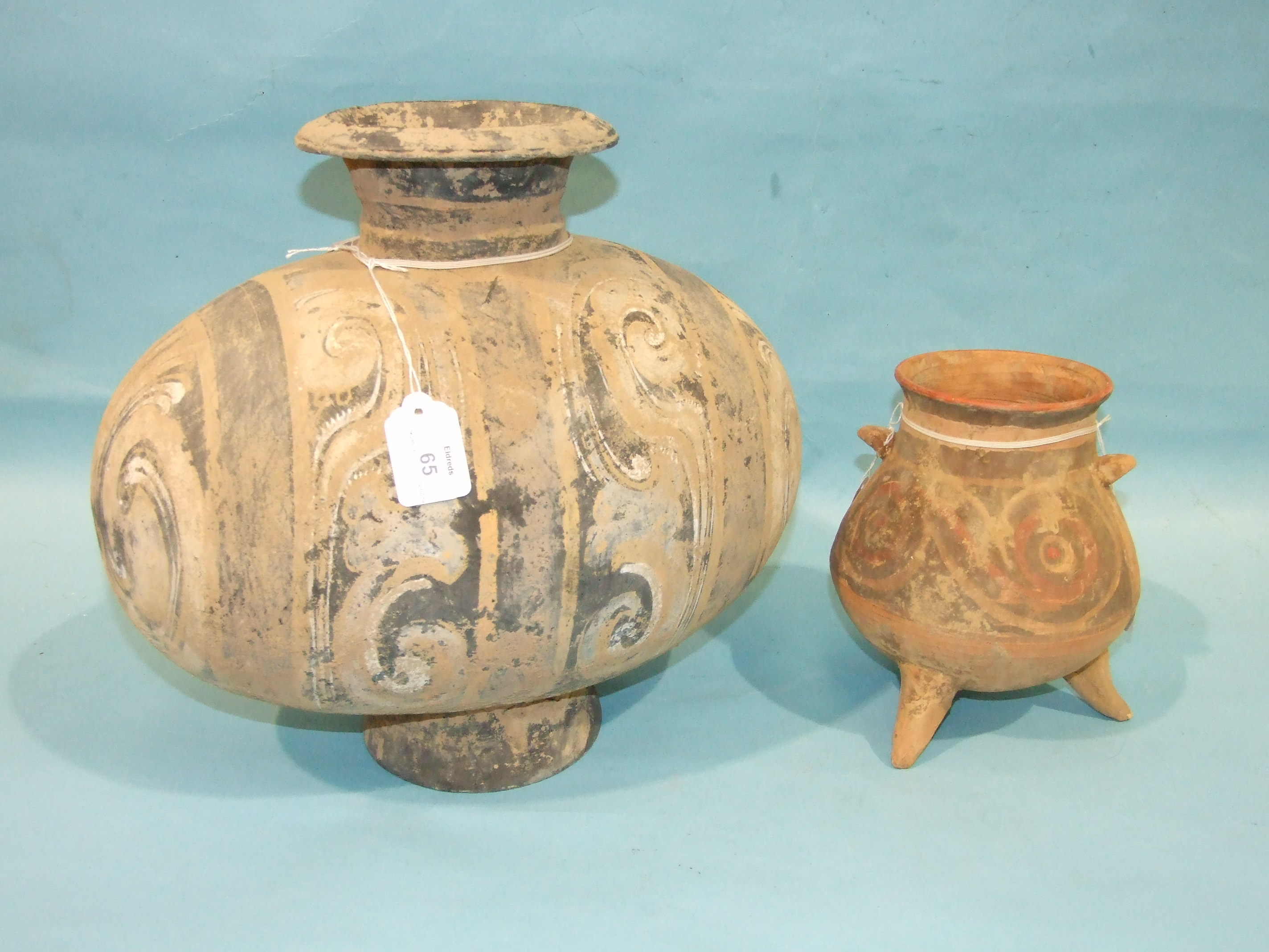 A Neolithic enamelled egg and cocoon jar and a similar smaller tripod vessel, (2).