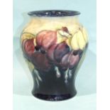 A Moorcroft mid-20th century baluster-shaped vase with wisteria decoration, impressed factory mark