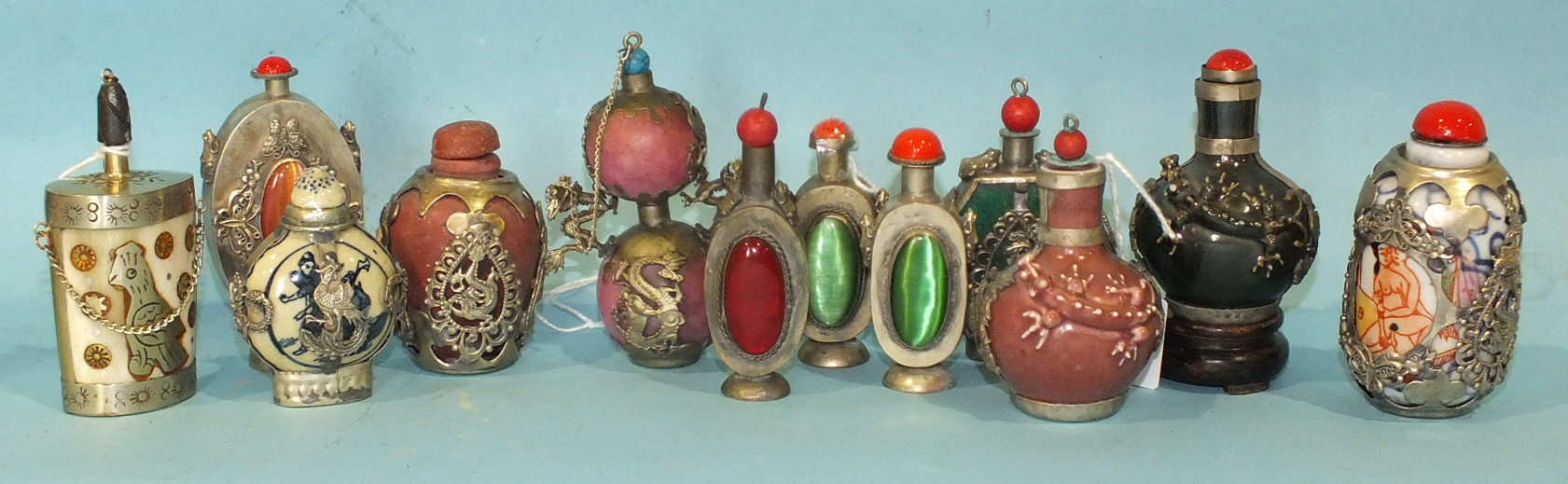 Twelve metal-mounted Oriental snuff bottles in various materials, (12).