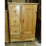 A pine cupboard with panelled cupboard door and drawers, 88.5cm wide, 134cm high.