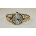 A ladies 9ct-gold-cased wrist watch by Buren, on plated expanding bracelet.