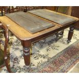 A 19th century mahogany pull-out dining table, the top with three spare leaves, on octagonal and
