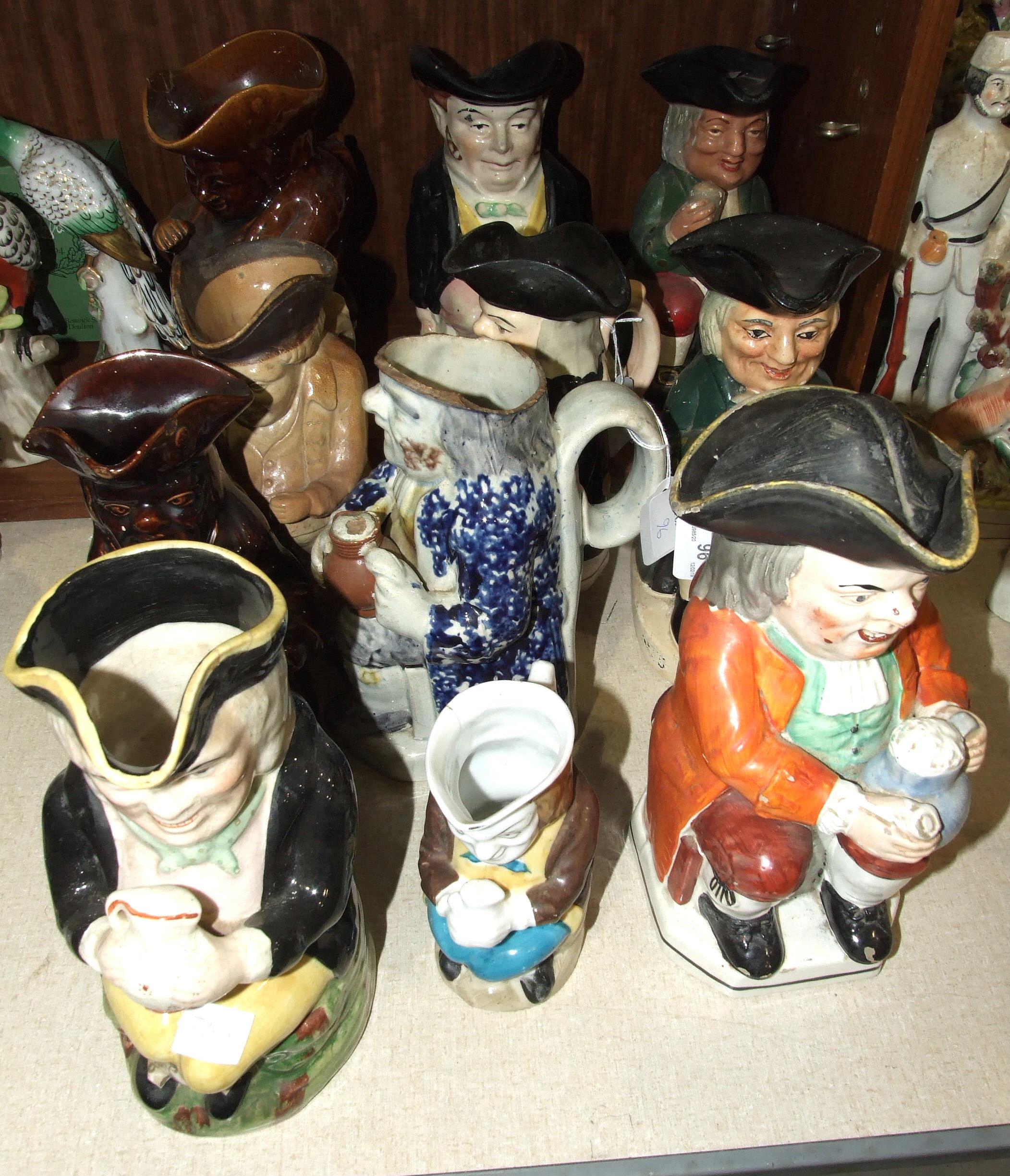 A collection of nine 19th century and later ceramic Toby jugs and two others, (damages and