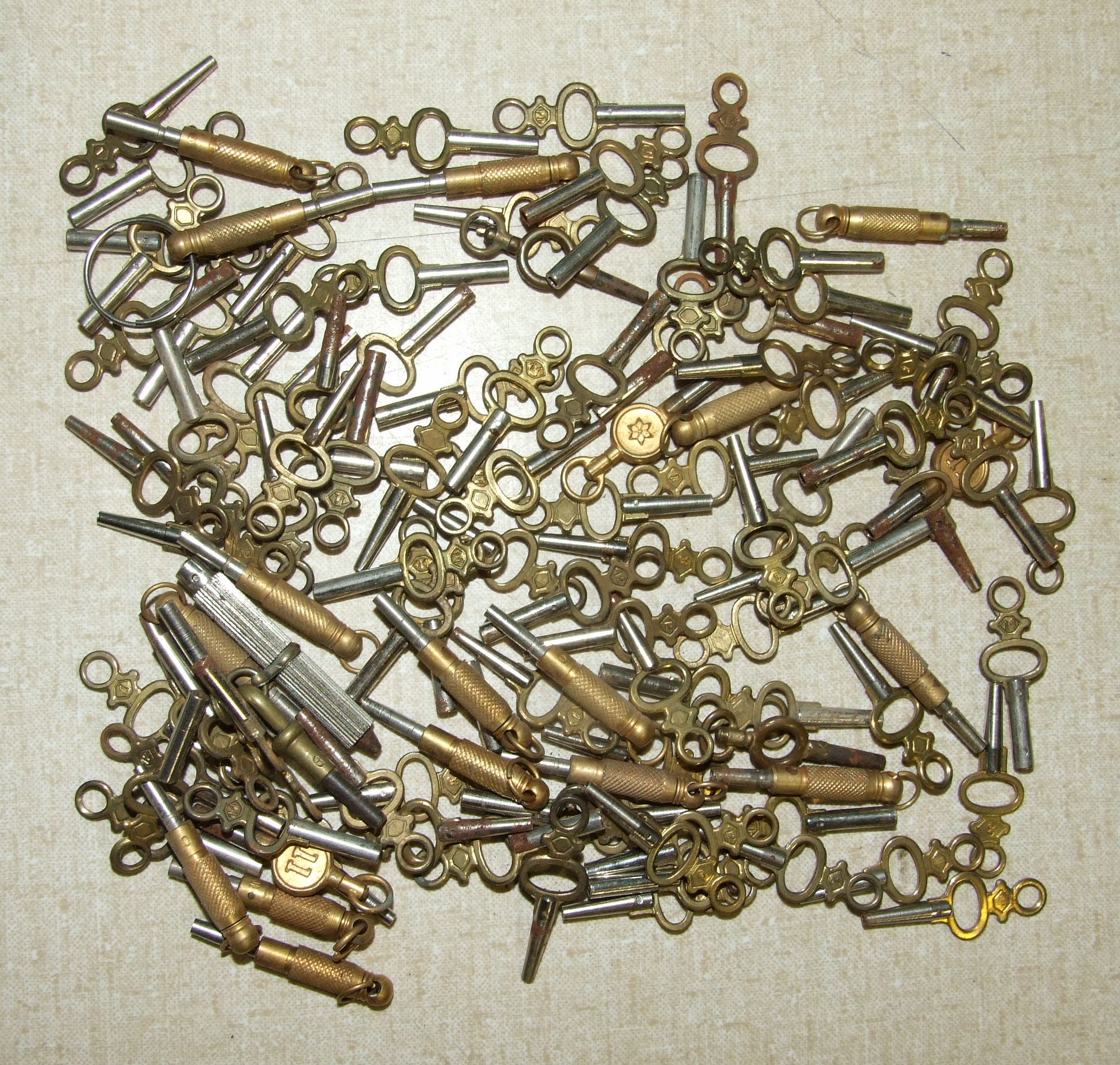 A collection of approximately one hundred and fifteen pocket watch keys.