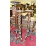 A pair of mahogany torchères, each with twist and carved column, on cabriole tripod support, 118cm