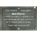 An early-20th century cast iron railway sign, painted white on black, "Southern Railway. Warning
