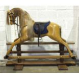 A Haddon rocking horse of varnished unpainted wood, with horse hair mane and tail and leather