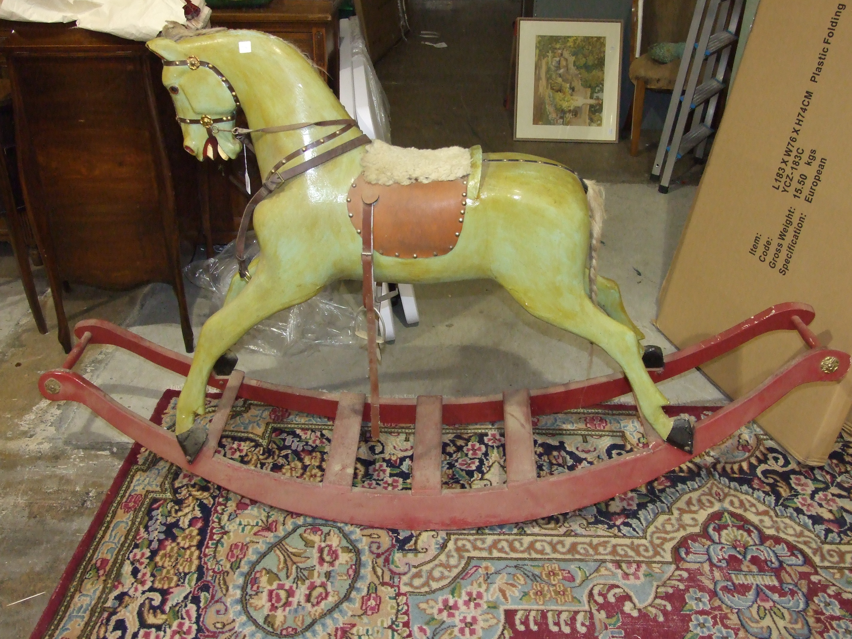 An early-20th century painted wood rocking horse on painted sleigh base and fitted with leather - Image 2 of 4