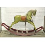 An early-20th century painted wood rocking horse on painted sleigh base and fitted with leather