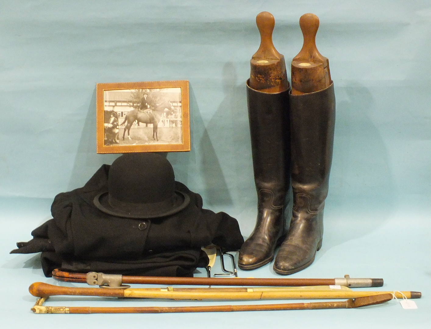 A hunting bowler hat by Tress & Co. Ltd for Moss Bros & Co. Ltd, a pair of riding boots, (size 5½