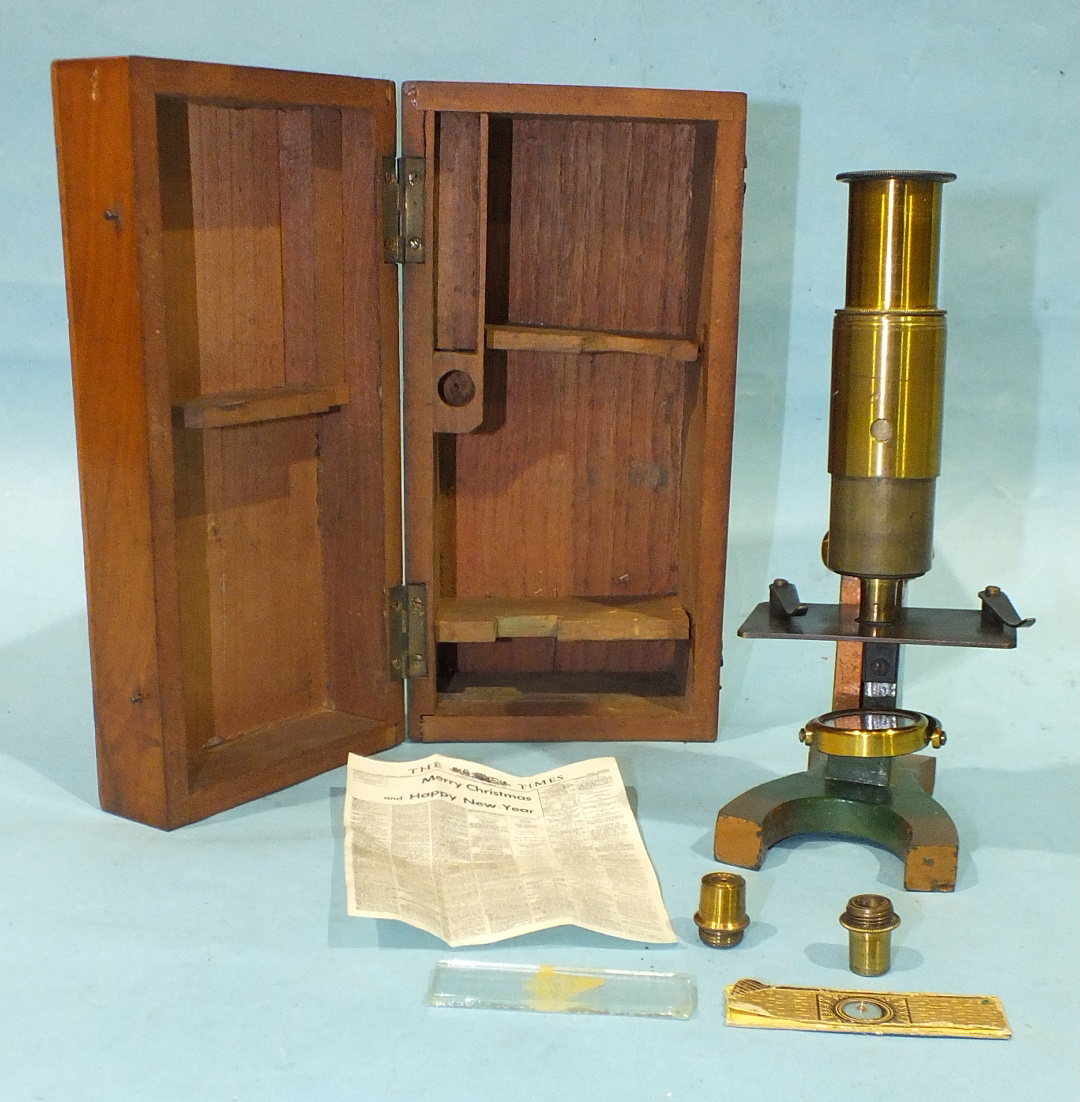 A small brass microscope, 17.5cm high, with accessories, in mahogany case.