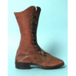A Victorian miniature leather boot, possibly a salesman's sample, of faded red leather with