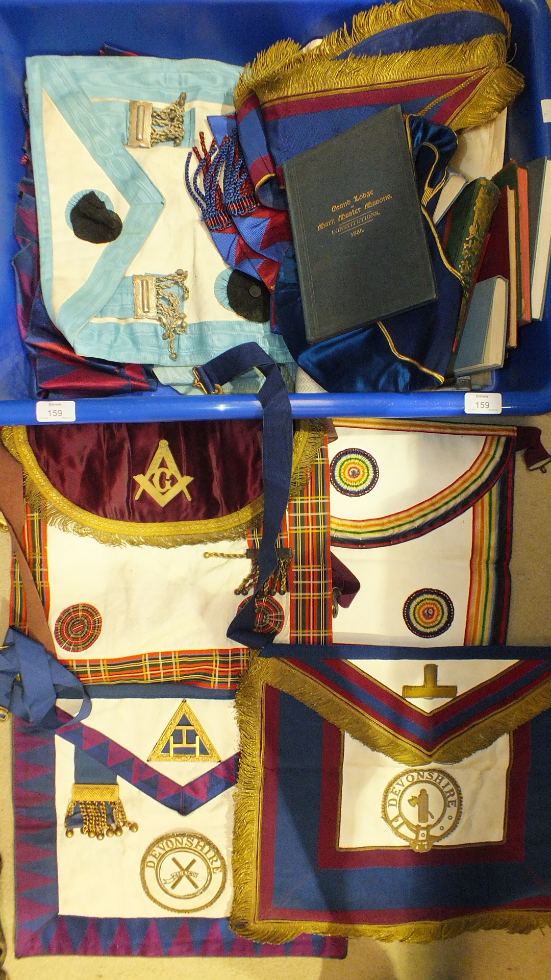 A collection of aprons, collars and Masonic ritual and constitution books, (all in soiled