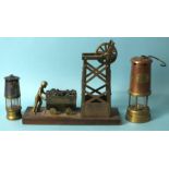 A brass model of a colliery and figure pushing a wagon of coal, a Hockley Lamp & Limelight Co.